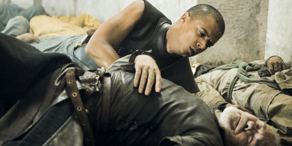 An injured Grey Worm next to a dead Barristan the Bold in Game of Thrones