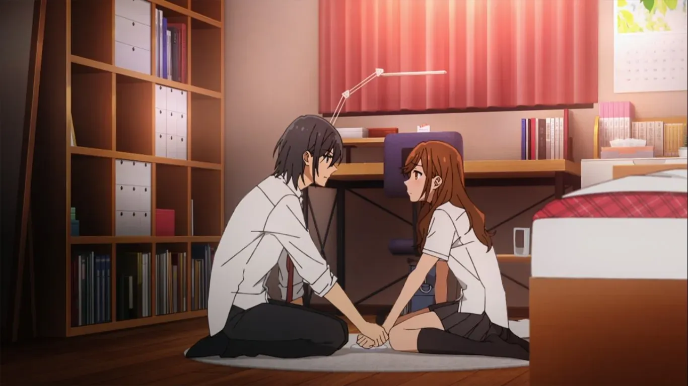 Hori and Miyamura holding hands on the floor 