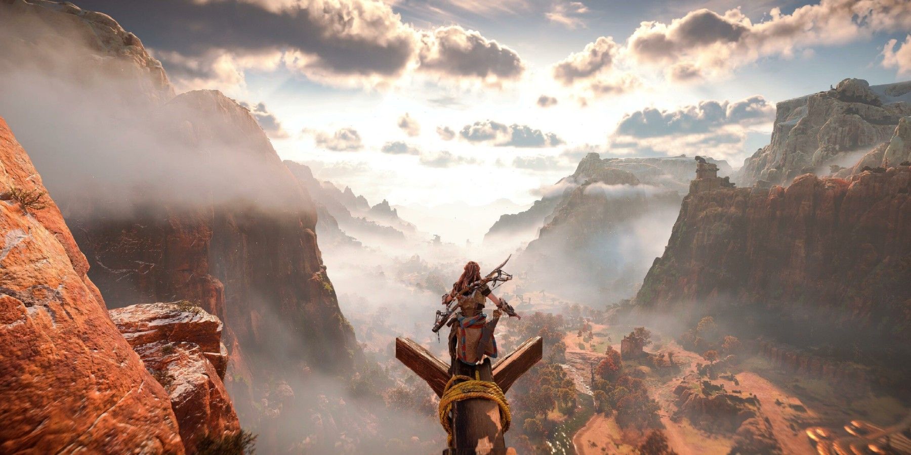 An image of Aloy standing over a ridge in Horizon Forbidden West
