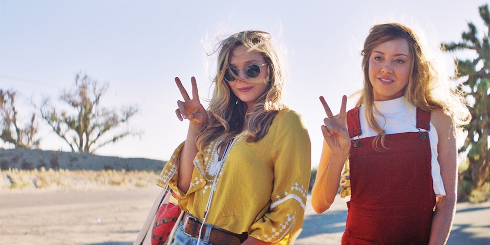 Ingrid Goes West - characters from the movie gesture peace signs with their fingers