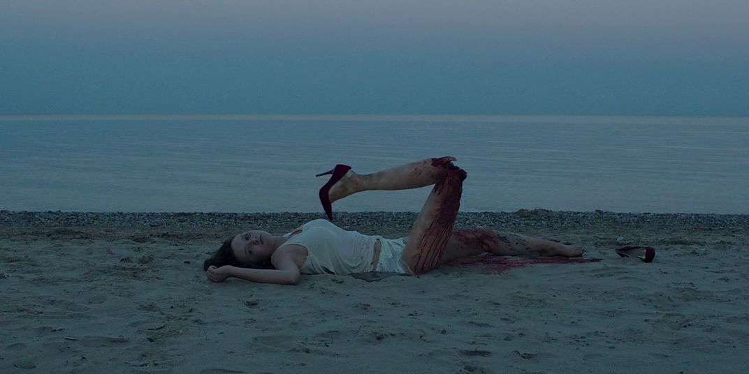 Mangled victim on the beach during introduction of It Follows Jump Scare