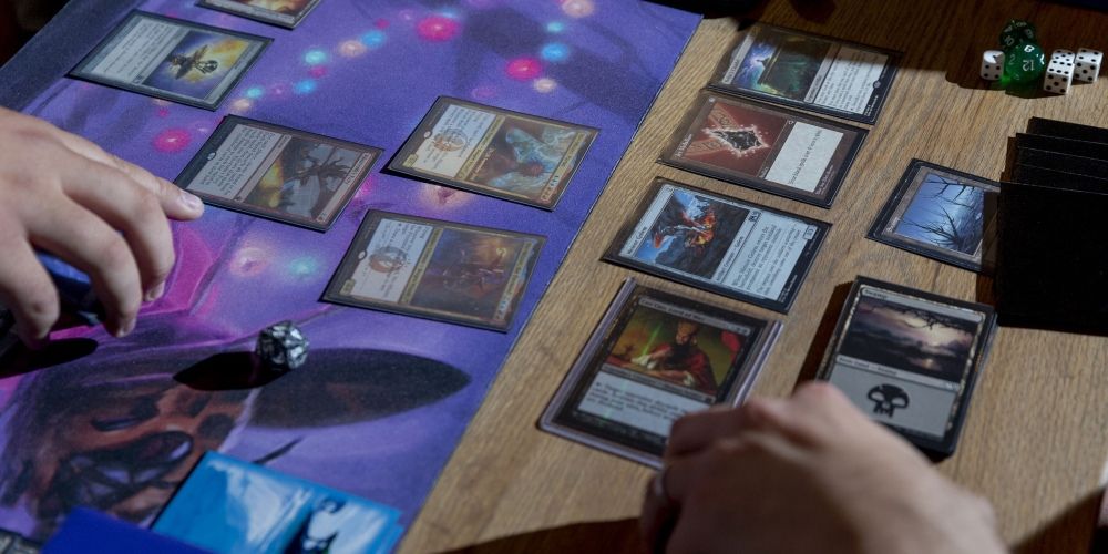 Players competing in a game of Magic: the Gathering