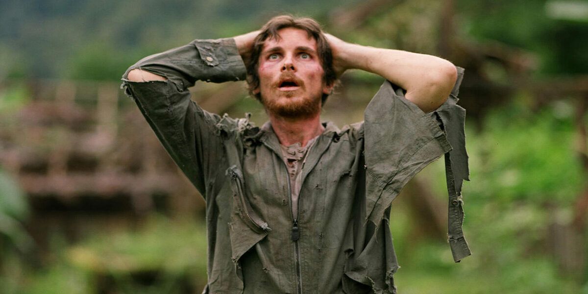 Christian Bale standing in disbelief in the film Rescue Dawn