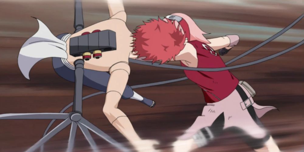 Sakura punches Sasori using chakra-enhanced strength in Naruto Shippuden.