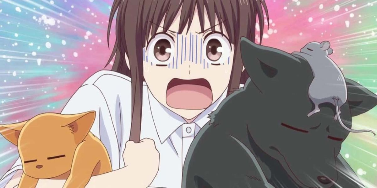 An image of Tohru Honda from Fruits Basket screaming while holding animal versions of Kyo, Yuki, and Shigure.