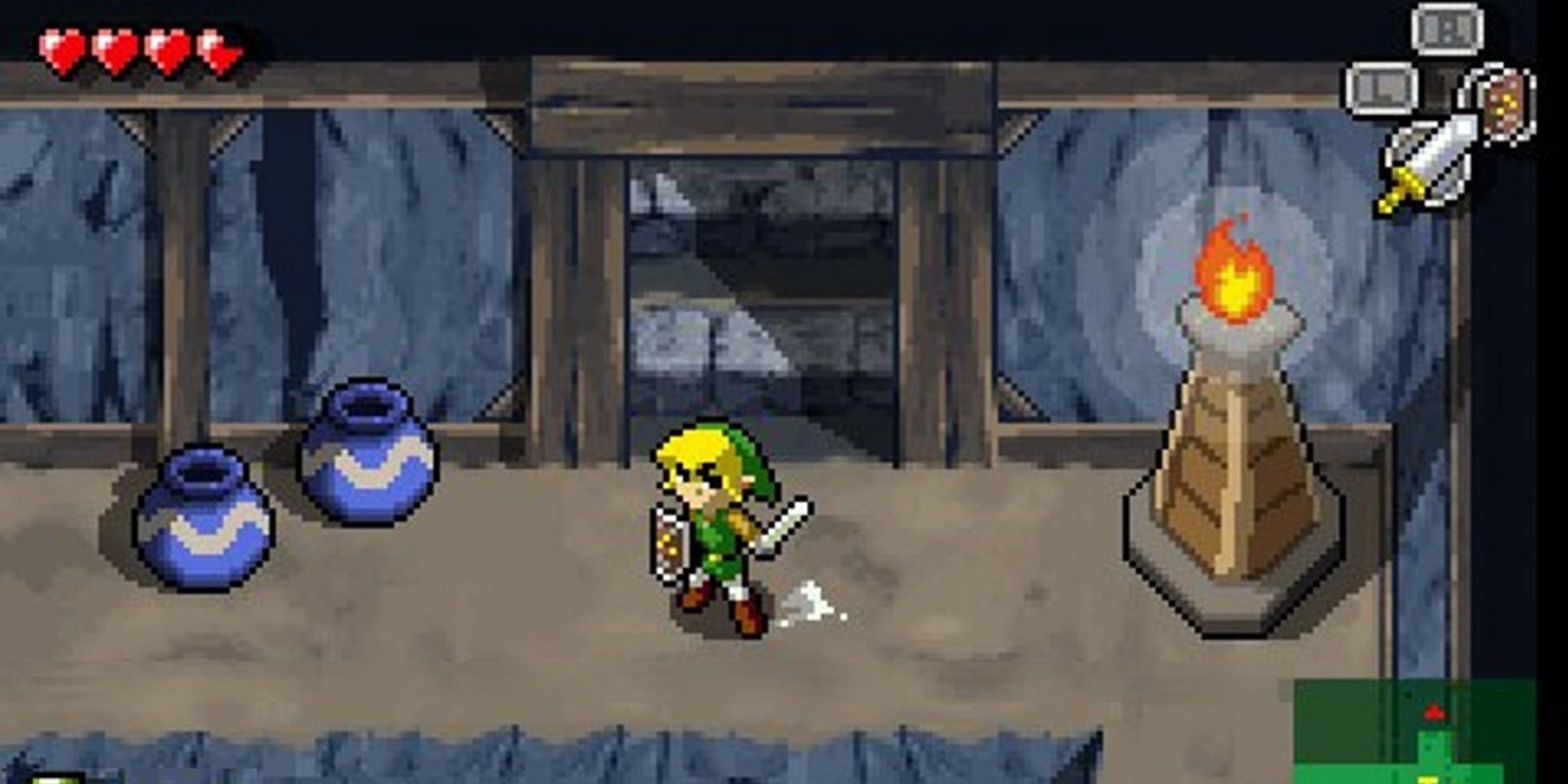 Link wields his shield and sword in a dungeon.