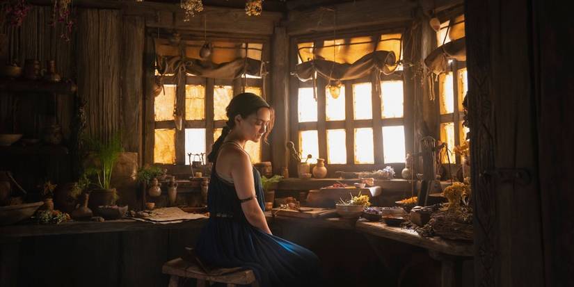 Bronwyn (Nazanin Boniadi) sits at a hutch in The Rings of Power