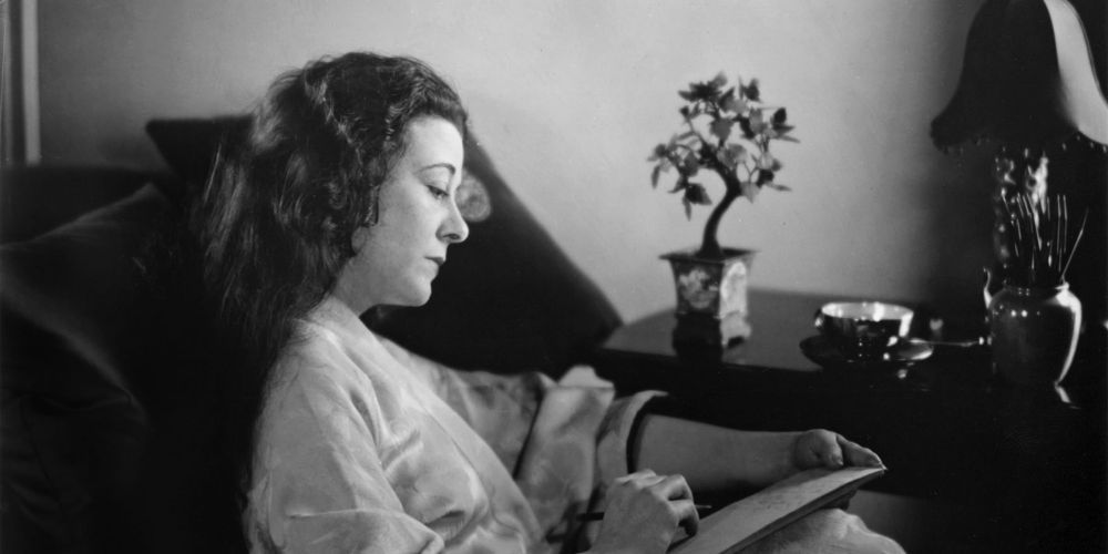 Frances Marion writing in notebook