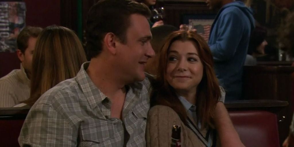 Marshall and Lily sit together in How I Met Your Mother.