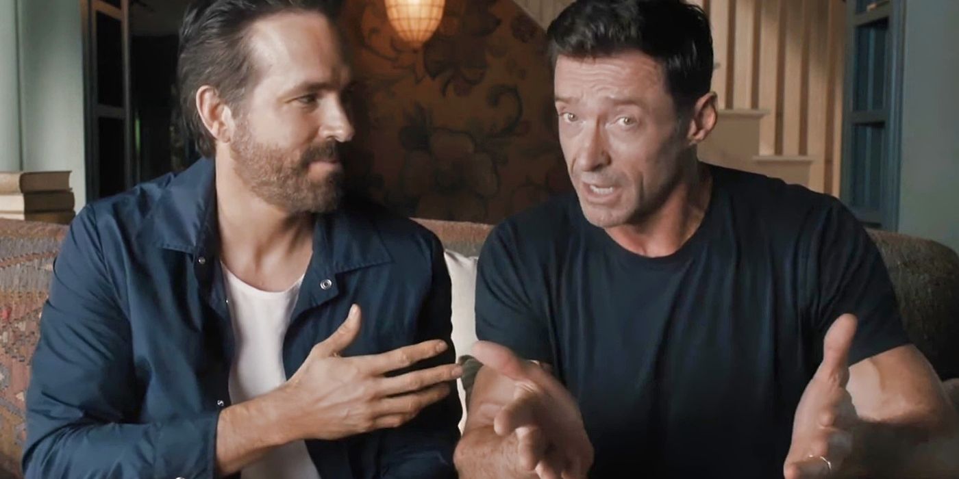 Ryan Reynolds looks at Hugh Jackman who's talking to the camera about Deadpool 3