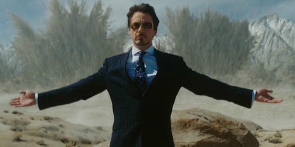 Tony Stark in the first Iron Man movie opening his arms in front of explosions