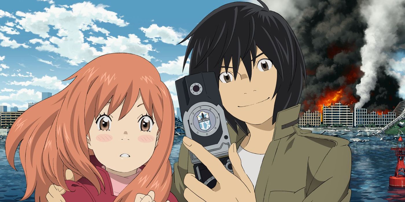 Saki and Akira from Eden of the East posing for a selfie while a building burns in the background.