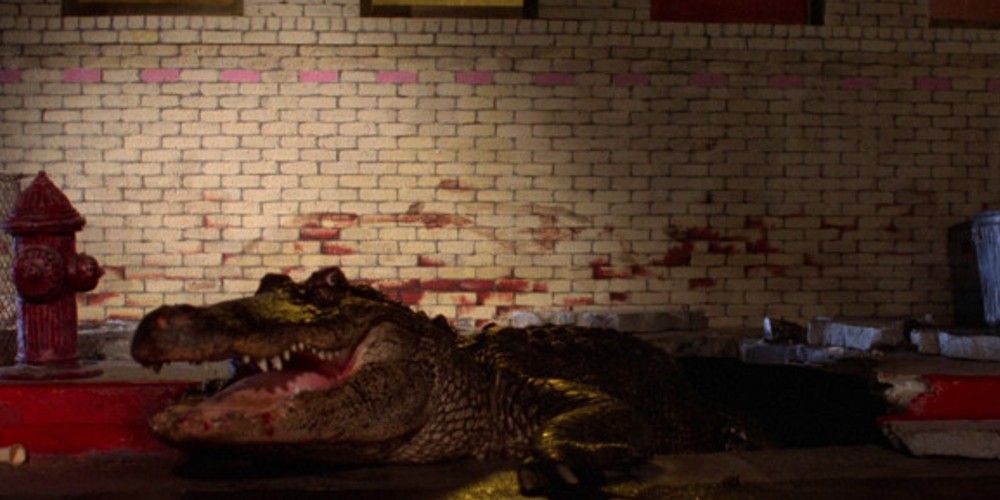 A screenshot from the 1980 film Alligator showing the alligator coming out of the sewer