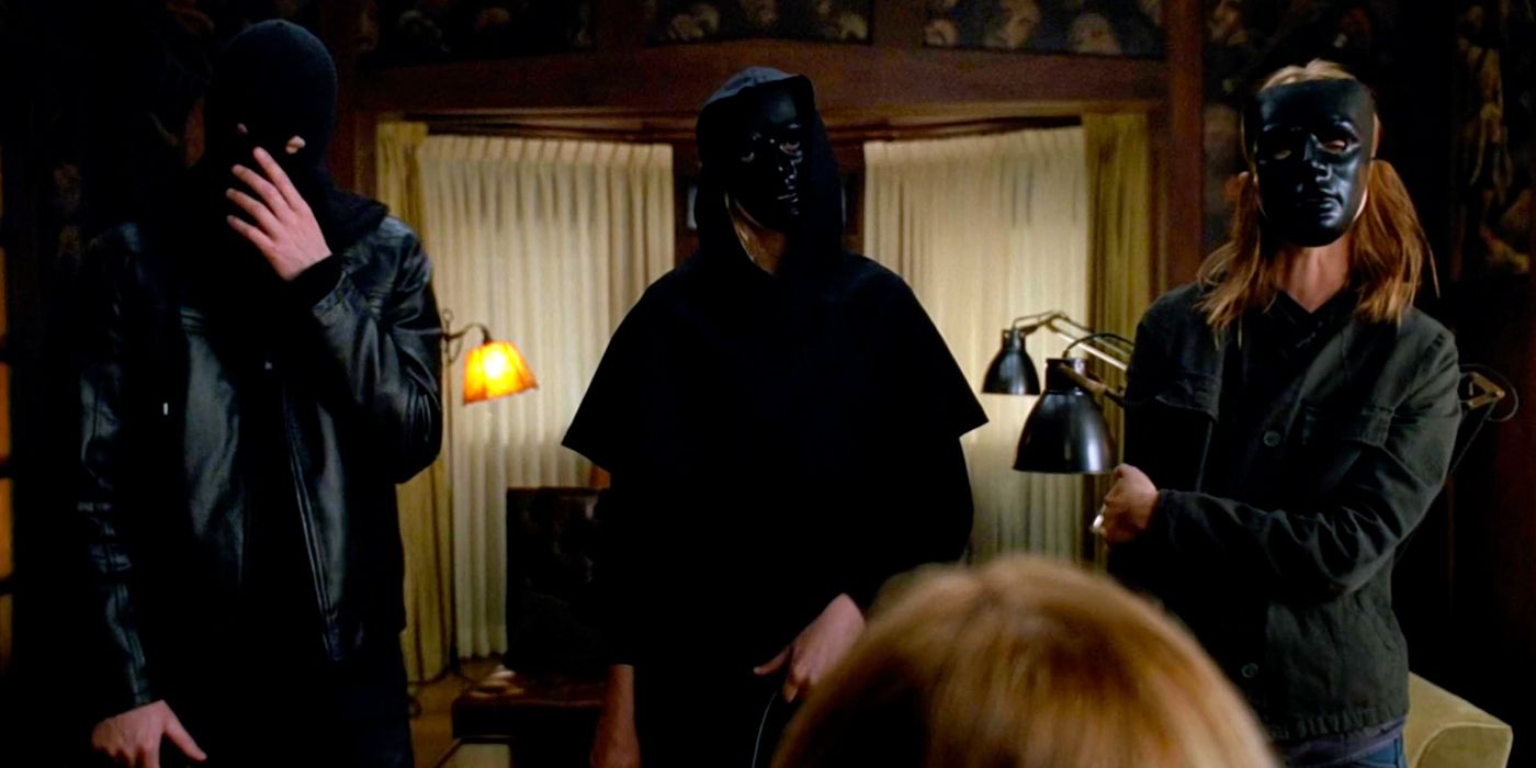 Masked characters in American Horror Story's Murder House 1966 home invasion scene. 