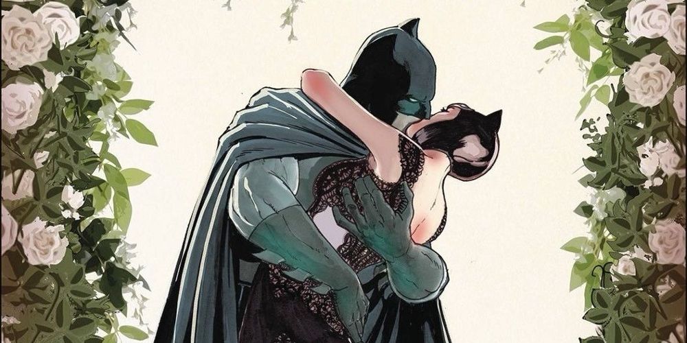 Batman and Catwoman kissing while dressed in a formal wedding dress