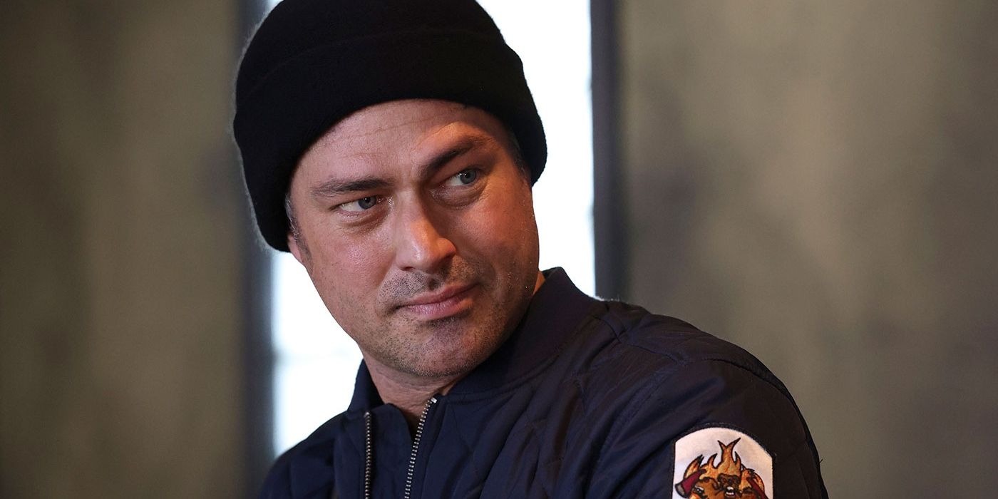 Chicago Fire's Kelly Severide (Taylor Kinney) in a CFD jacket and hat looking off.
