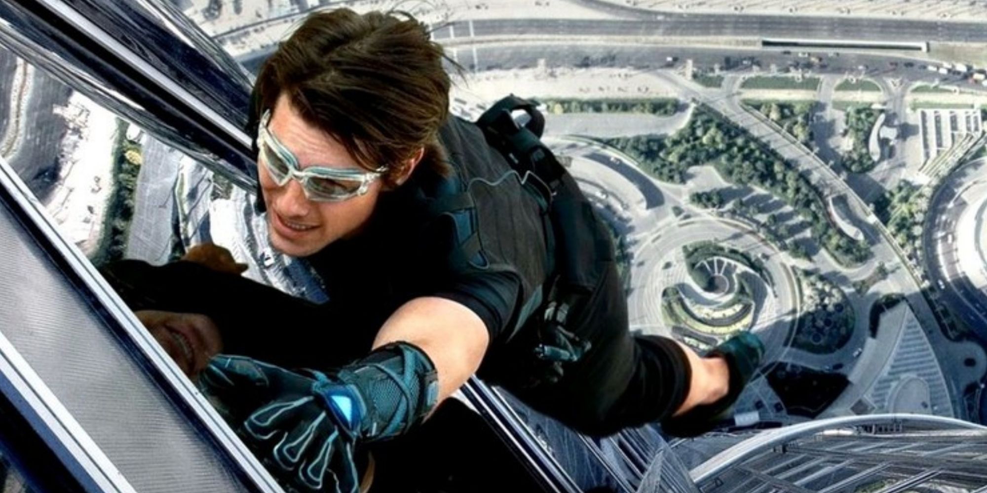 Ethan Hunt climbing a building in Mission Impossible Ghost Protocol