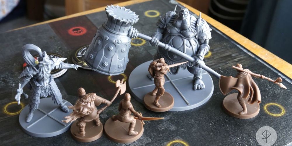 Four players fighting Ornstein and Smough in Dark Souls: The Board Game.