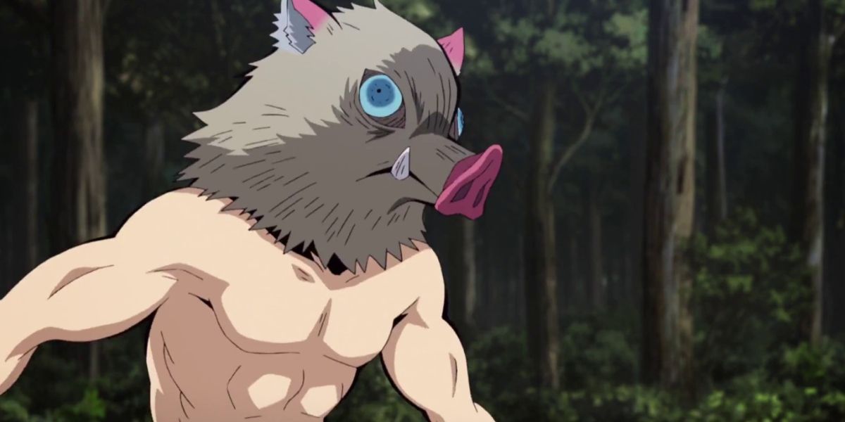 Shirtless, masked Inosuke standing against the forest backdrop