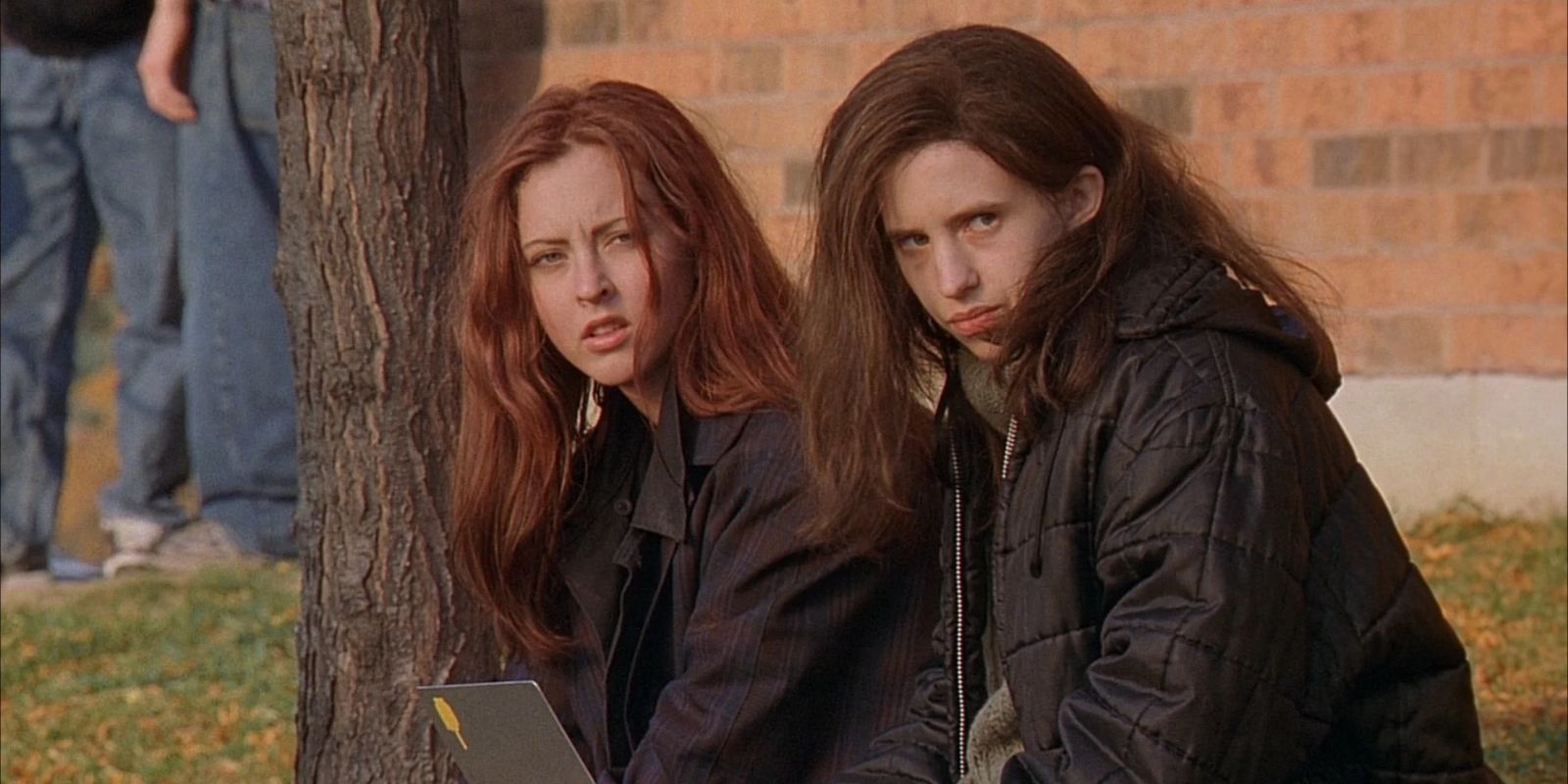 Ginger and Brigitte awkwardly staring at school in Ginger Snaps movie.