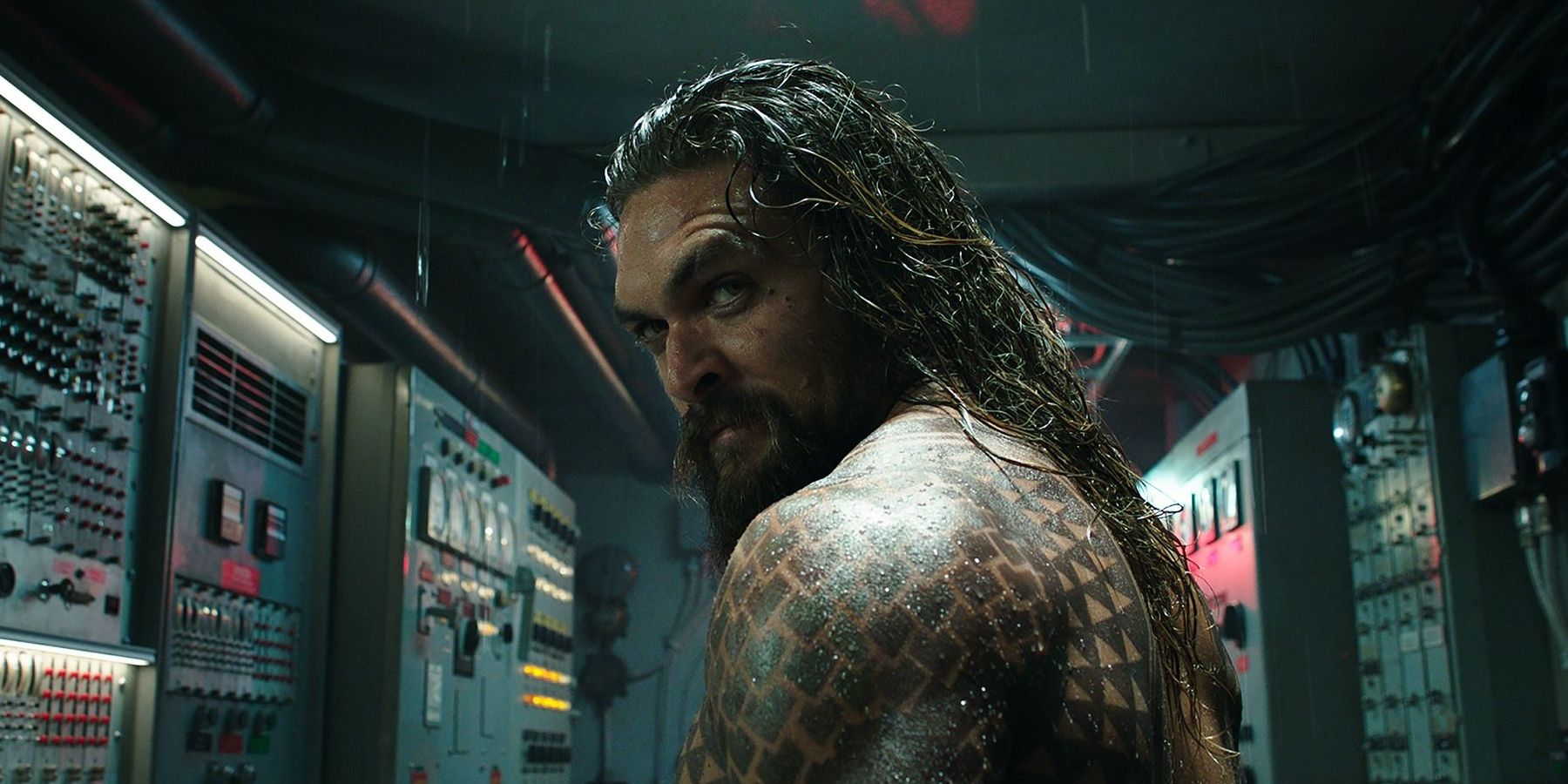 Aquaman looks back at the camera while in a room