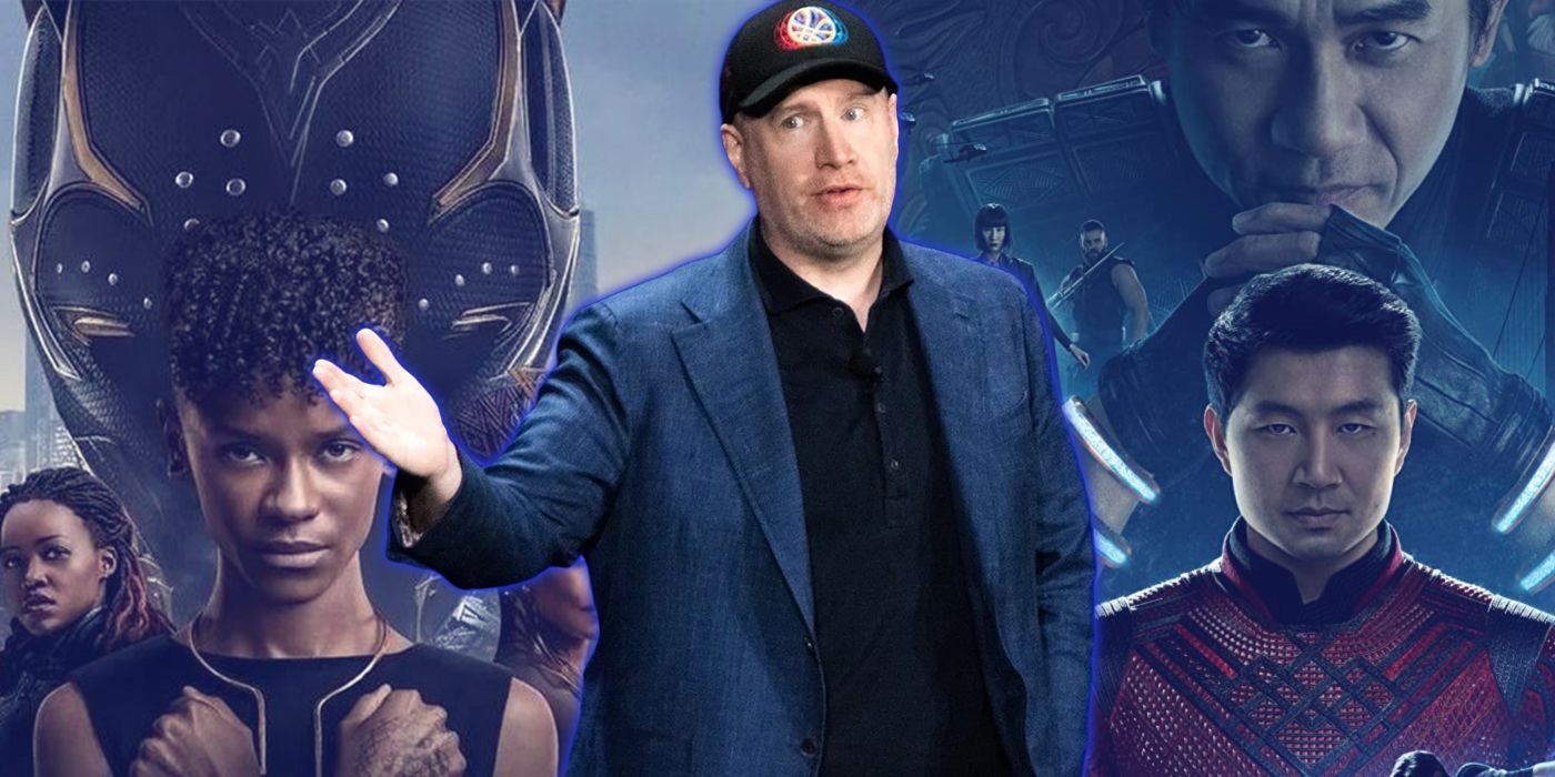 Kevin Feige with a Black Panther Wakanda Forever and Shang-Chi poster behind him
