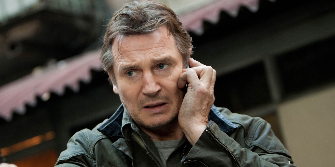 Liam Neeson talks on the phone in a still from Taken.