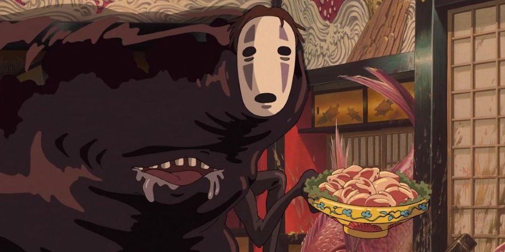 No-Face looking at the camera in Spirited Away with food in his hand