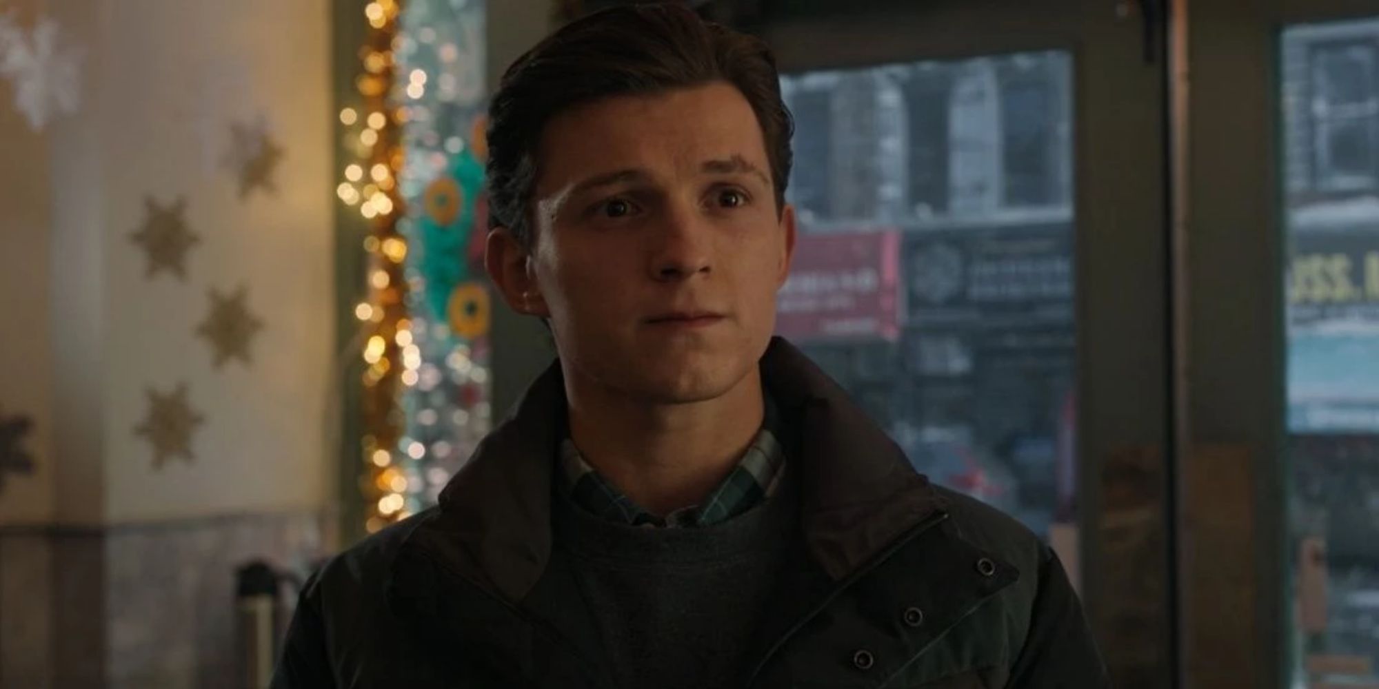 MCU's Peter Parker (Tom Holland) stands in a diner looking wistful in Spider-Man No Way Home