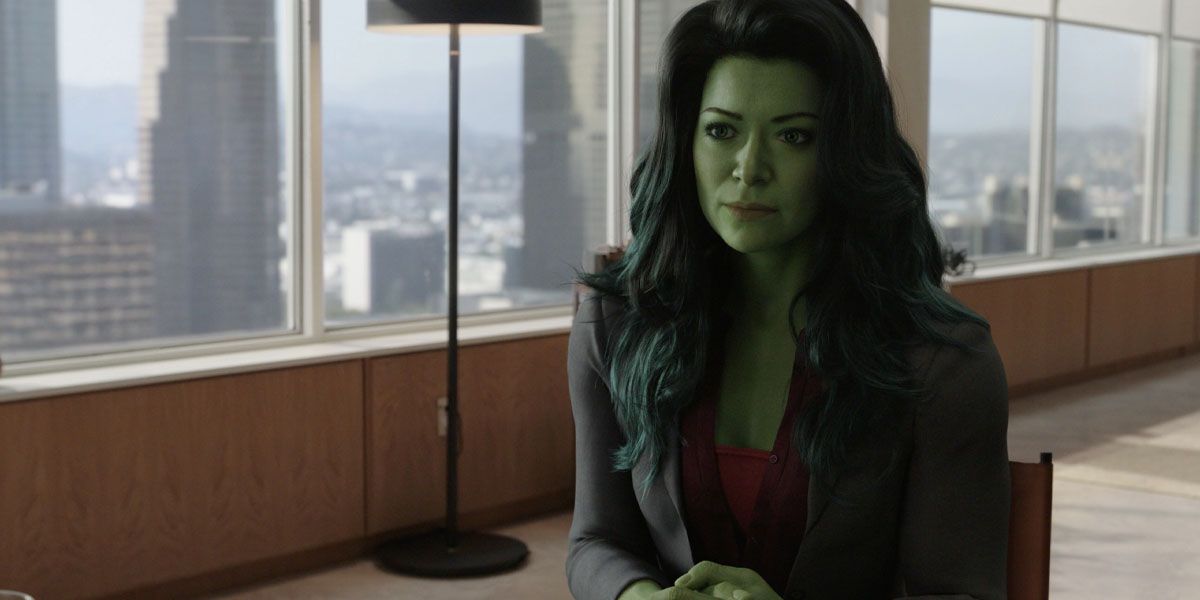 Tatiana Maslany as She-Hulk sits at her desk in She-Hulk: Attorney at Law