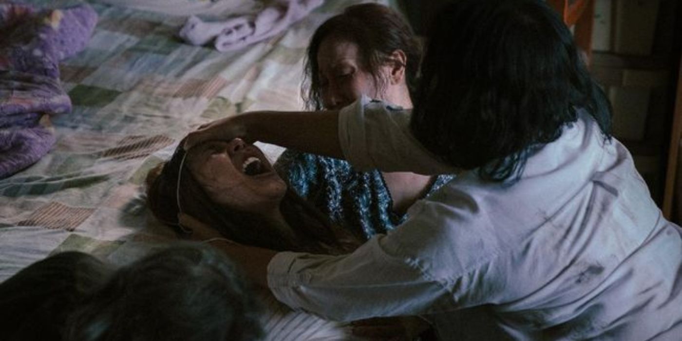 Women try to restrain a possessed girl in The Medium.