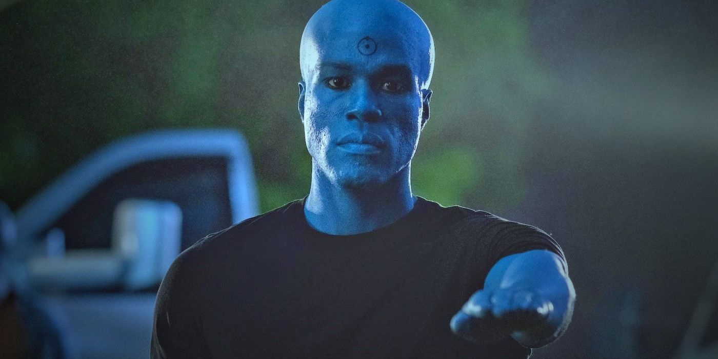 Dr. Manhattan reaching with his hand towards him, taken from the HBO series