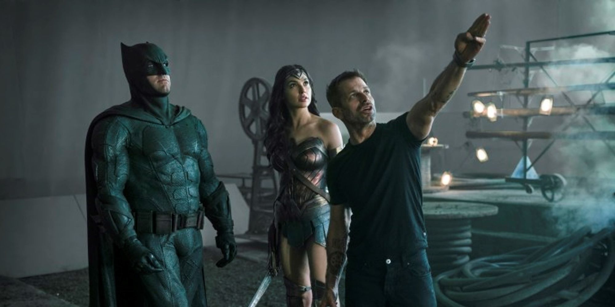 Zack Snyder, Gal Gadot and Ben Affleck standing on the set of Justice League