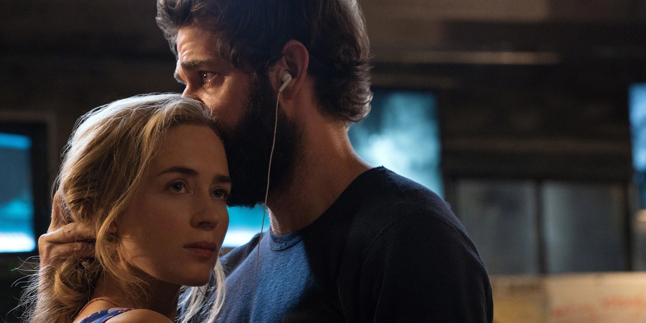Lee and Evelyn embracing with music in the horror film, A Quiet Place