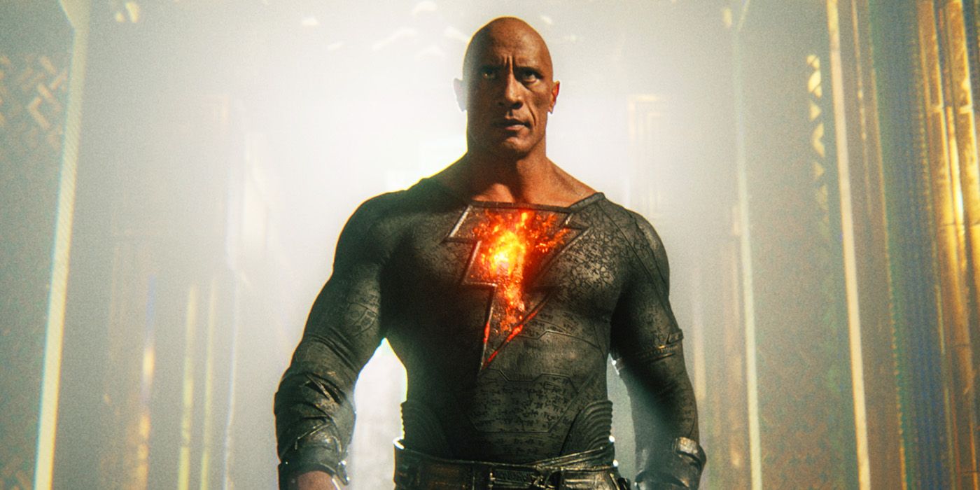 Black Adam: Dwayne Johnson's title character walks ominously as the lightning symbol on his chest glows red.