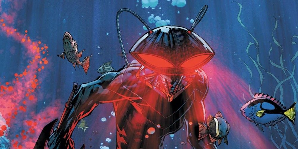 Black Manta with his glowing red eyes underwater, fish swimming around in DC Comics