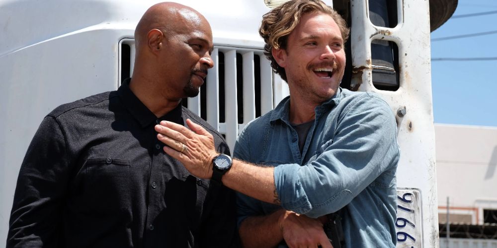 Martin Riggs laughing next to Roger Murtaugh in Lethal Weapon