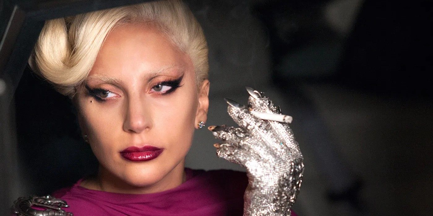 Lady Gaga in American Horror Story, holding a cigarette with a silver glove.