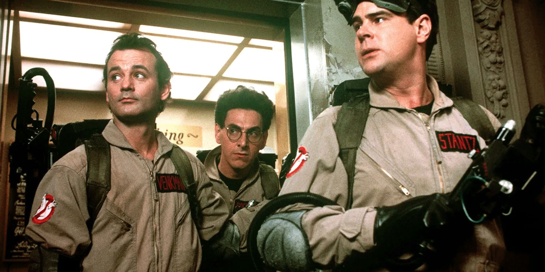 Bill Murray, Harold Ramis, and Dan Akroyd stand inside an elevator in Ghostbusters.