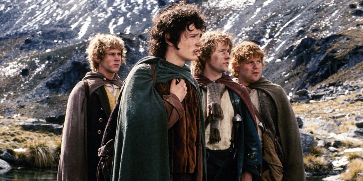 Frodo, Sam, Merry and Pippin standing in a valley in Lord of the Rings: The Fellowship of the Ring.