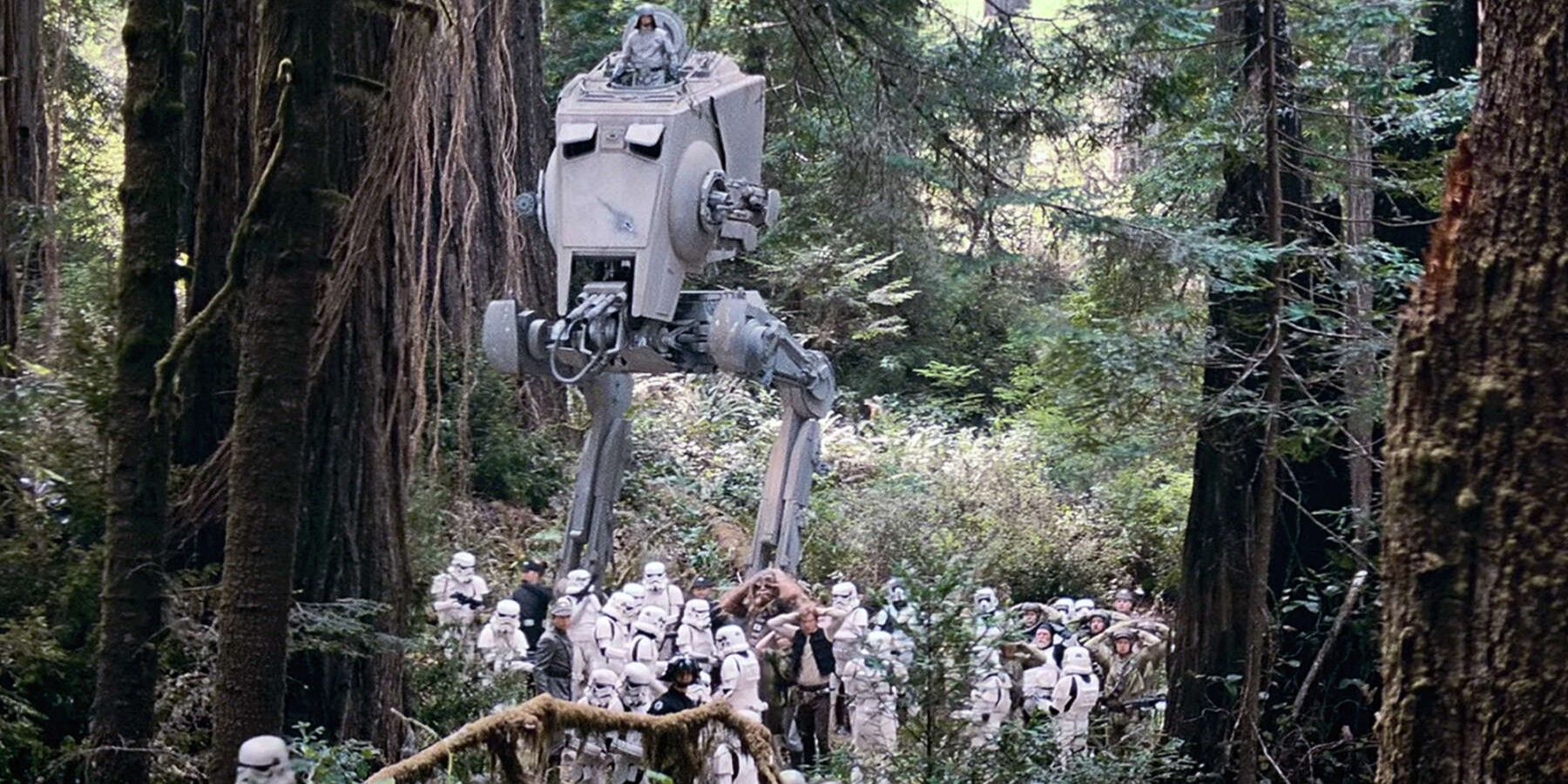 Stormtroopers march Han Solo and Chewbacca through a forest on Endor.