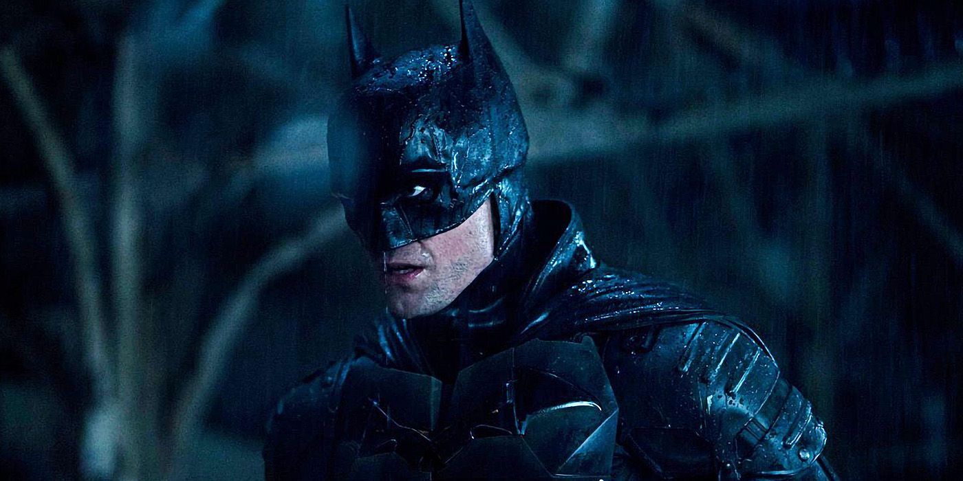 The Batman's Robert Pattinson suited-up, standing in the rain.