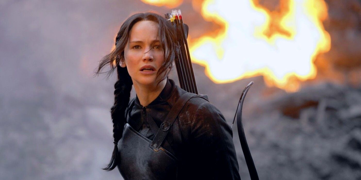 Katniss looking concerned as fire burns behind her in The Hunger Games: Mockingjay - Part 1