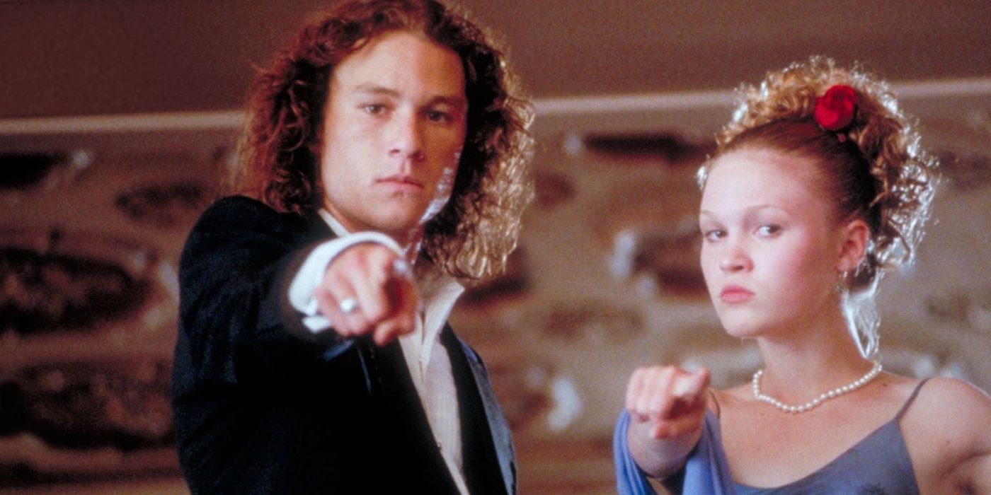 Patrick and Kat dressed in a gown and suit pointing at the screen in 10 Things I Hate About You