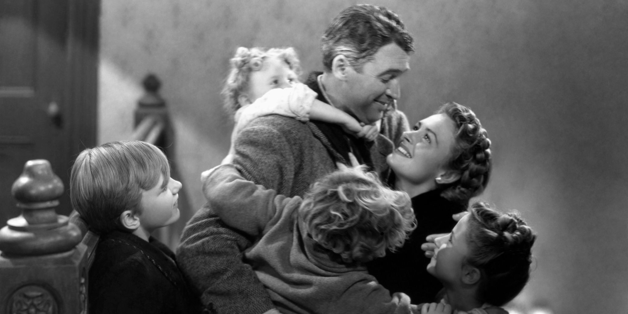 George Bailey hugs his family in It's A Wonderful Life