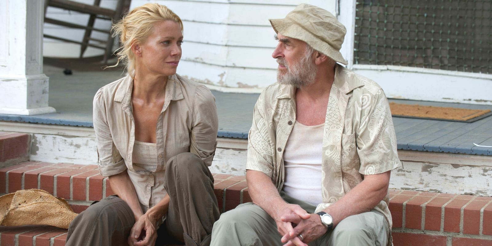 The Walking Dead's Andrea (Laurie Holden) and Dale (Jeffrey DeMunn) sitting on a porch.