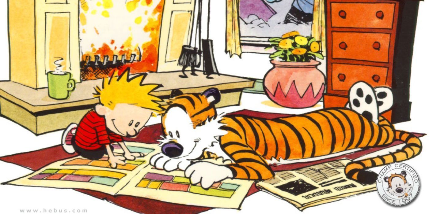 Calvin and Hobbes reading the Sunday Funnies while lying on the floor