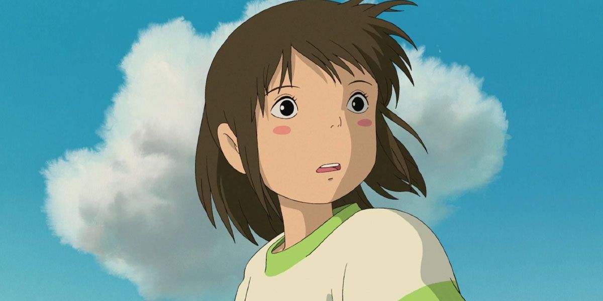 Chihiro looks back against a blue sky in Spirited Away