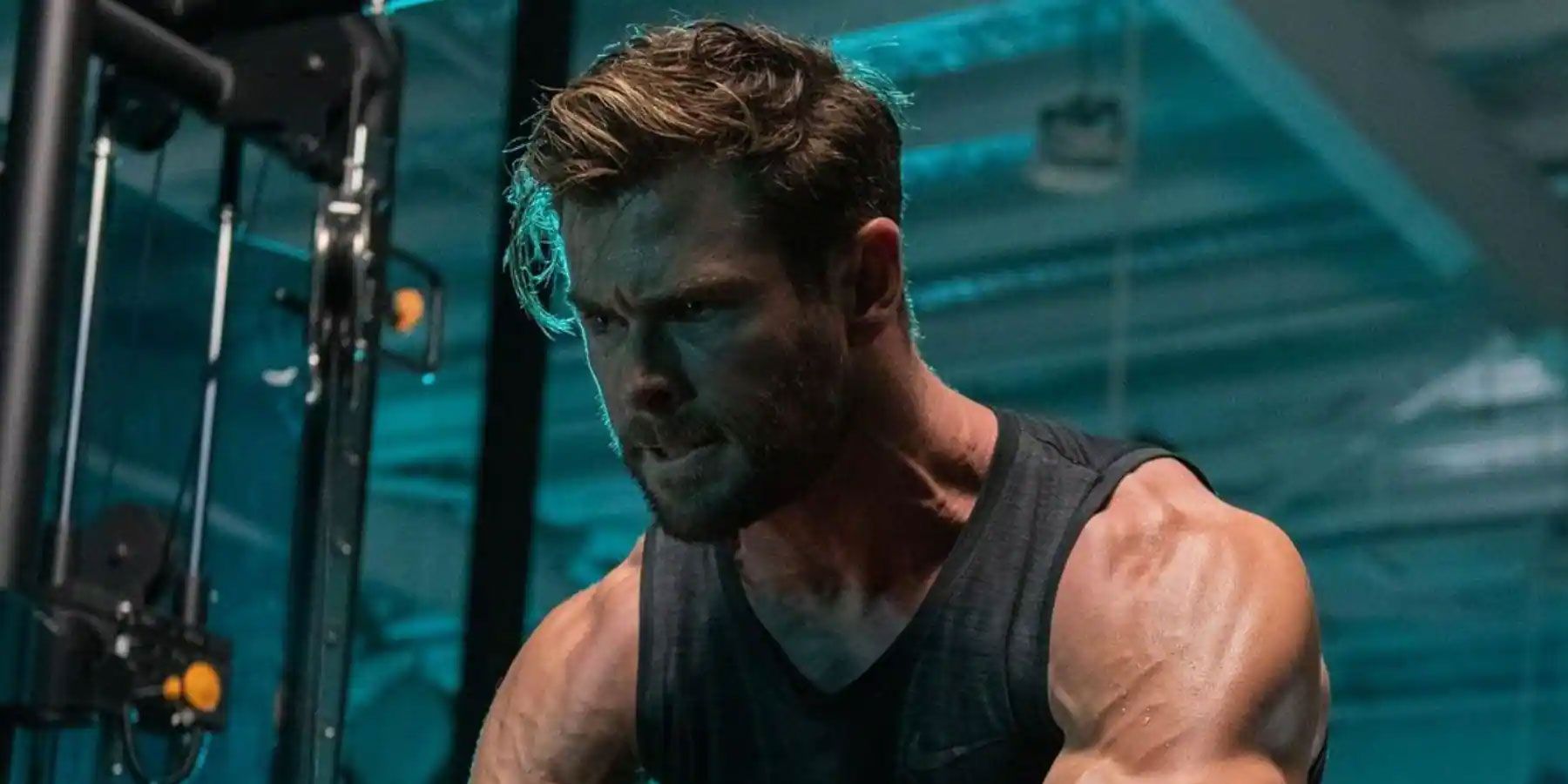 Chris Hemsworth working out inside a large industrial building.