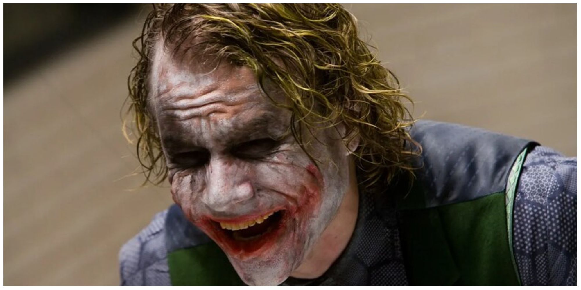 The Joker in the Dark Knight laughing while being interrogated